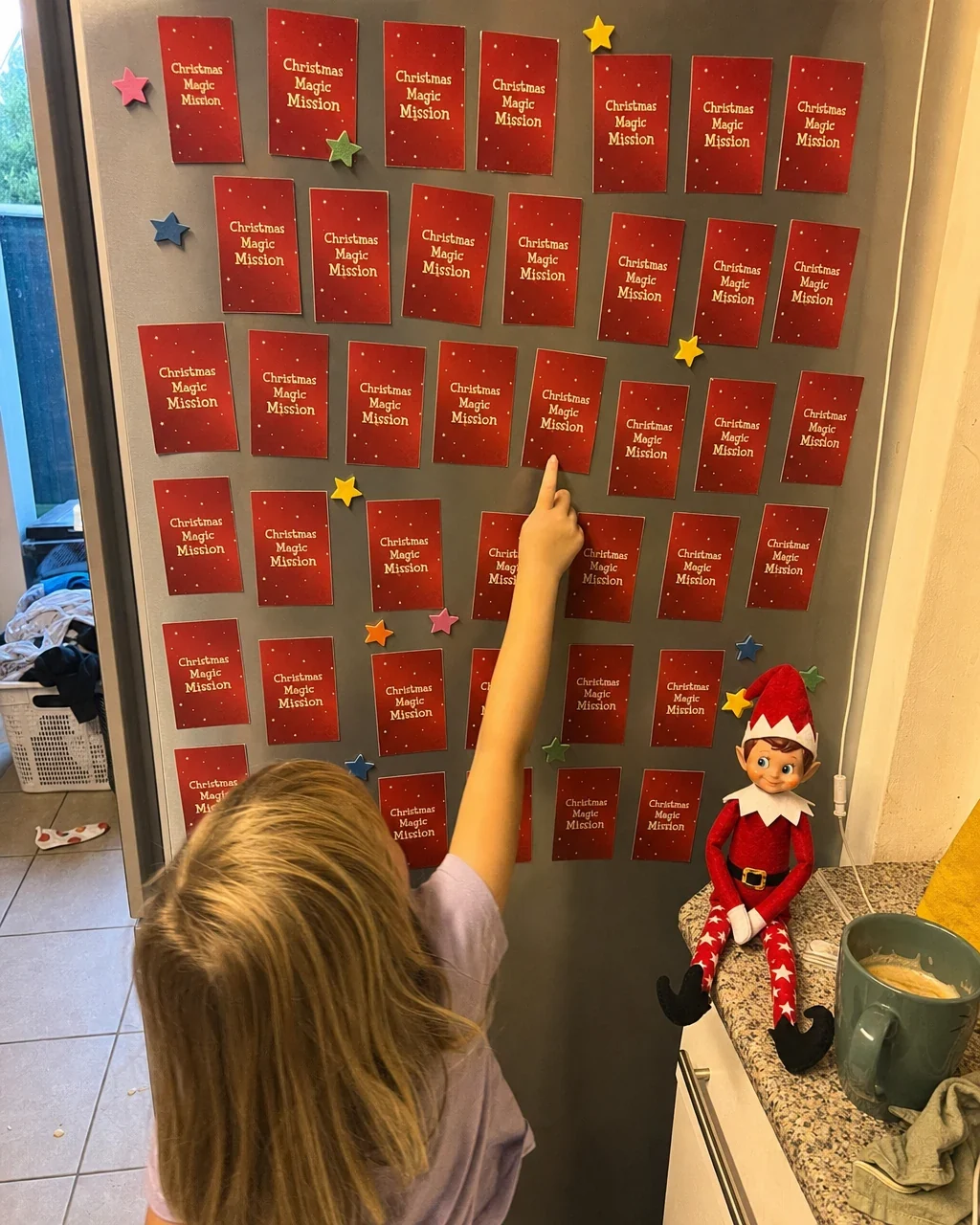 A fridge door covered with the month&rsquo;s used mission cards and foam stars