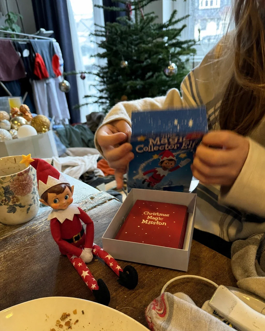 A parent packing the used mission cards back into the box after Christmas